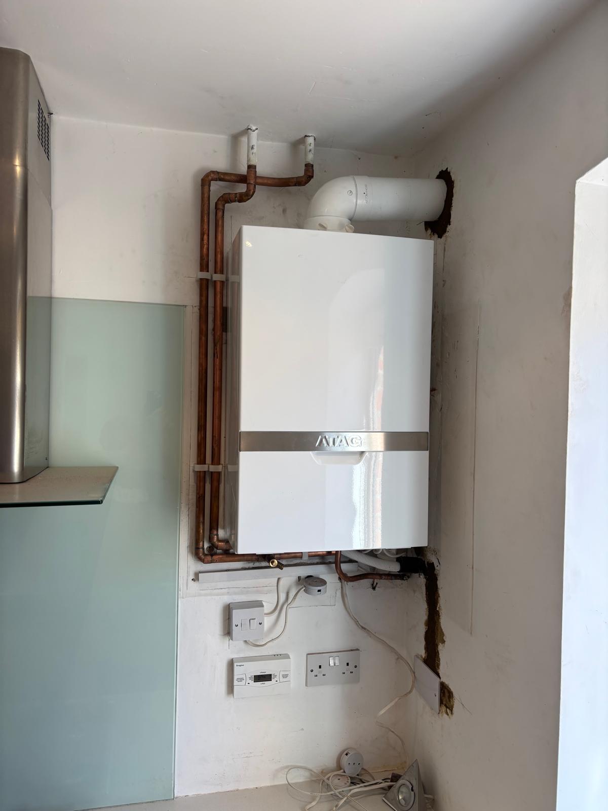 New boiler installed in a kitchen corner with tidy copper piping